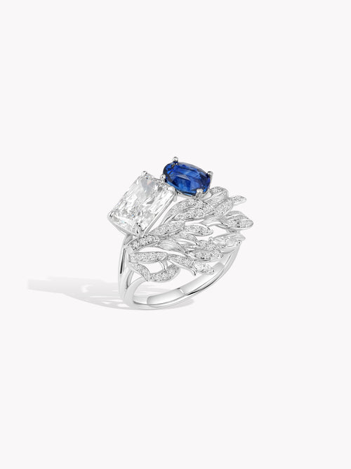 Swan wing diamond ring with oval royal blue sapphire centerpiece