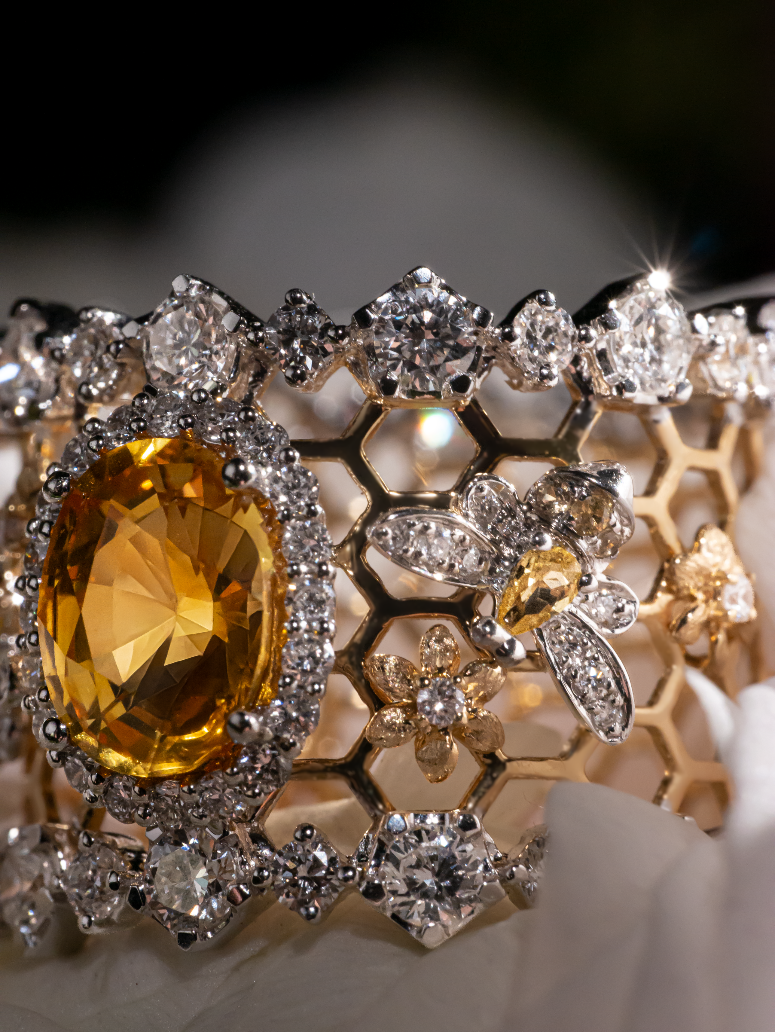 Honeycomb openwork ring with oval yellow sapphire center and pave stones