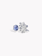 Open gemstone ring with blue round center stone and crystal bird-like cluster