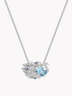 Swan-shaped gemstone necklace with light blue round center stone and pavé details