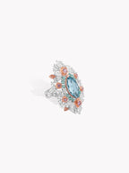 Floral lace garden ring with aquamarine marquise center and openwork side settings