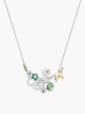 Silver-tone cat pendant necklace with green gemstone accents and dangling charms, long chain.