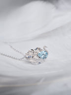 Swan gemstone pendant necklace with light blue stones and clear pavé on chain