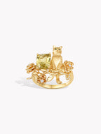 Gold cat guardian rose ring with seated cat, cushion-cut light green gemstone and blooms
