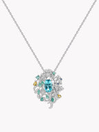 Gemstone pendant necklace with teal center stone and halo of white diamonds