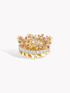 Gold-tone ring with pink flower cluster design and a central white strip of stones