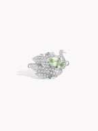 Silver swan-style ring with mint-green oval center stone and pavé wing details