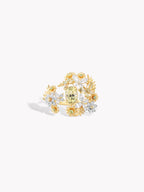 Gold floral cluster ring with openwork band and mixed white and yellow stones