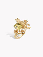 Gold cat guardian rose ring with cushion-cut green gemstone and floral accents