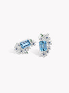Aquamarine blue rectangular stud earrings with floral halo and tiny clear stone accents