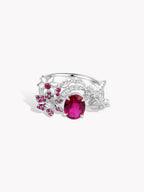 Silver lily-of-valley ring with small round pink-red stones and a large oval center