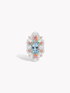 Floral lace garden ring with aquamarine marquise center and orange halo stones
