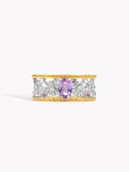 Openwork diamond ring with brushed band, gold edge, purple oval center stone
