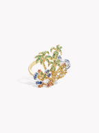 Gold-tone ring with green palm tree design, blue stones, and pink highlights