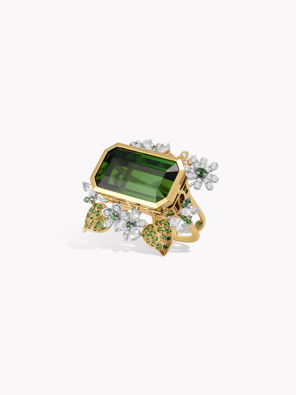 Gold ring with emerald-cut green center stone and diamond-like floral accents