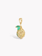 Lemon-shaped pendant with gold-tone bail and green faceted gemstone top