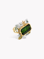 Gold ring with green emerald-cut tourmaline and diamond floral side settings