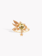 Gold hummingbird ring, yellow center stone, ornate wing and tail accents