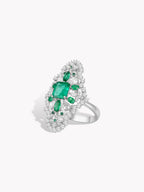 Emerald-green cluster ring with square center stone and surround of clear stones
