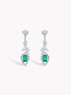 Emerald-green square drop earrings with diamond pavé calla lily motifs, dangling