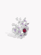 Silver-tone cocktail ring with red center gem, purple accents, and clear pavé floral design