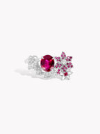 Silver floral ring with oval pink-red center gemstone and sparkling side clusters