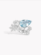 Silver-tone ring with blue oval gemstone and baguette crystal snowflake setting
