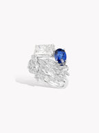 Swan wing diamond ring featuring oval blue sapphire side view