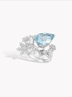 Silver-tone ring with large blue oval gemstone and prong-set snowflake band