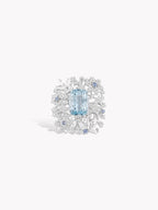 Aquamarine and diamond snowflake ring with blue oval center stone and icy halo
