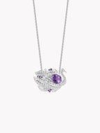 Close-up swan pendant necklace with oval purple sapphire and pavé detailing