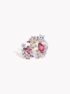 Silver-tone open ring, floral gem cluster with pink pear center stone, side view