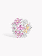 White gold pink sapphire ring with oval center stone, halo of round pink gems