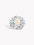 Starfish opal ring with silver setting, pale opal center, blue and green accents