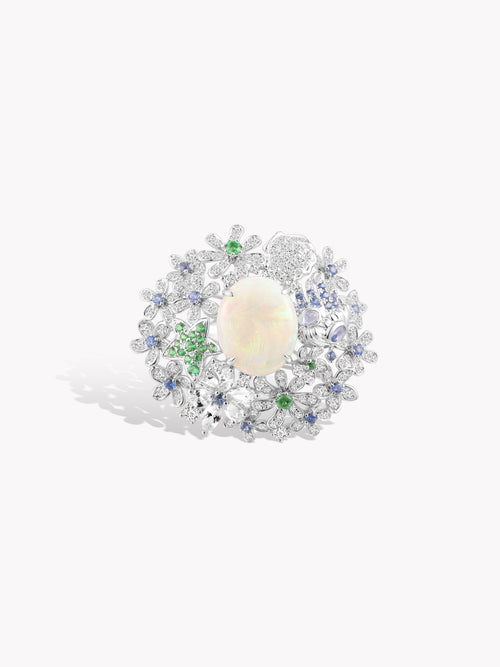 Starfish opal ring with silver setting, pale opal center, blue and green accents