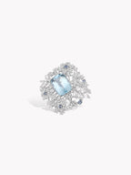 Aquamarine and diamond starburst halo ring with oval light-blue center gemstone
