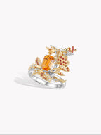 Cocktail ring front view with orange marquise center stone, clear accents, curved band