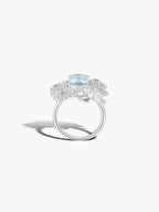 Aquamarine and diamond snowflake star ring with oval light-blue center stone, side view