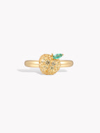 Gold-tone ring with sparkling peach fruit charm and small green leaf detail