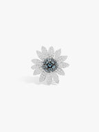 Sunflower gemstone ring with dark blue center and sparkly silver petals, silver-tone band