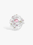 Floral branch ring with pink oval gemstone, pink and yellow accents, clear diamonds