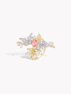 Butterfly motif ring with pink center gemstone, gold band, clear pavé stones