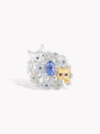 Twin cat sapphire ring with oval blue center, floral border, silver band
