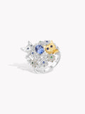 Silver ring with oval blue sapphire center, small cat faces, floral cluster prongs