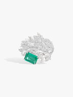 Emerald and diamond ring with wing-like setting and green rectangular center stone
