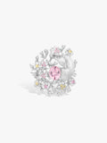 Floral branch ring with pink oval center gemstone and clear diamonds in white metal