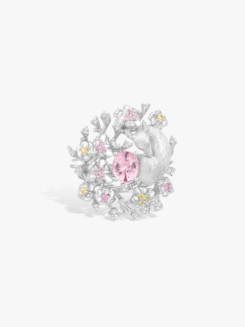 Floral branch ring with pink oval center gemstone and clear diamonds in white metal