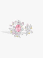 Top view of strawberry ring with pink oval gemstone and diamond pavé flowers, white metal