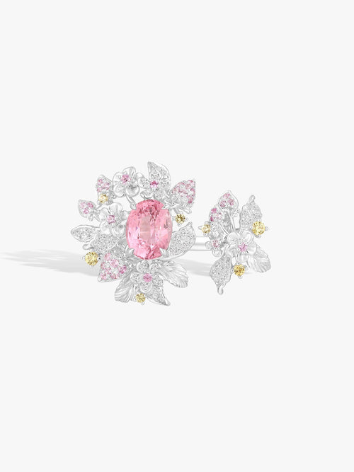 Top view of strawberry ring with pink oval gemstone and diamond pavé flowers, white metal