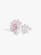 Side view strawberry ring with pink oval center stone, diamond pavé leaves, white metal